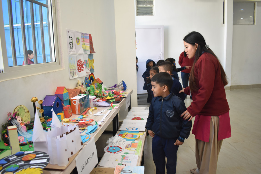 Students displaying artwork at school art and craft exhibition