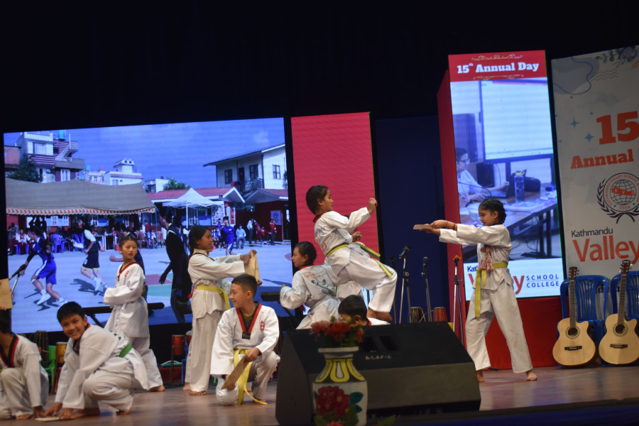 small students are perform karate on stage